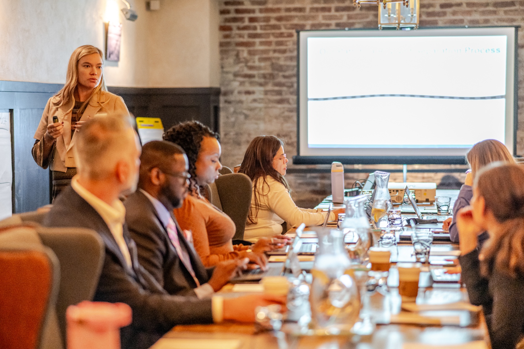 Presenter leading a boardroom-style session