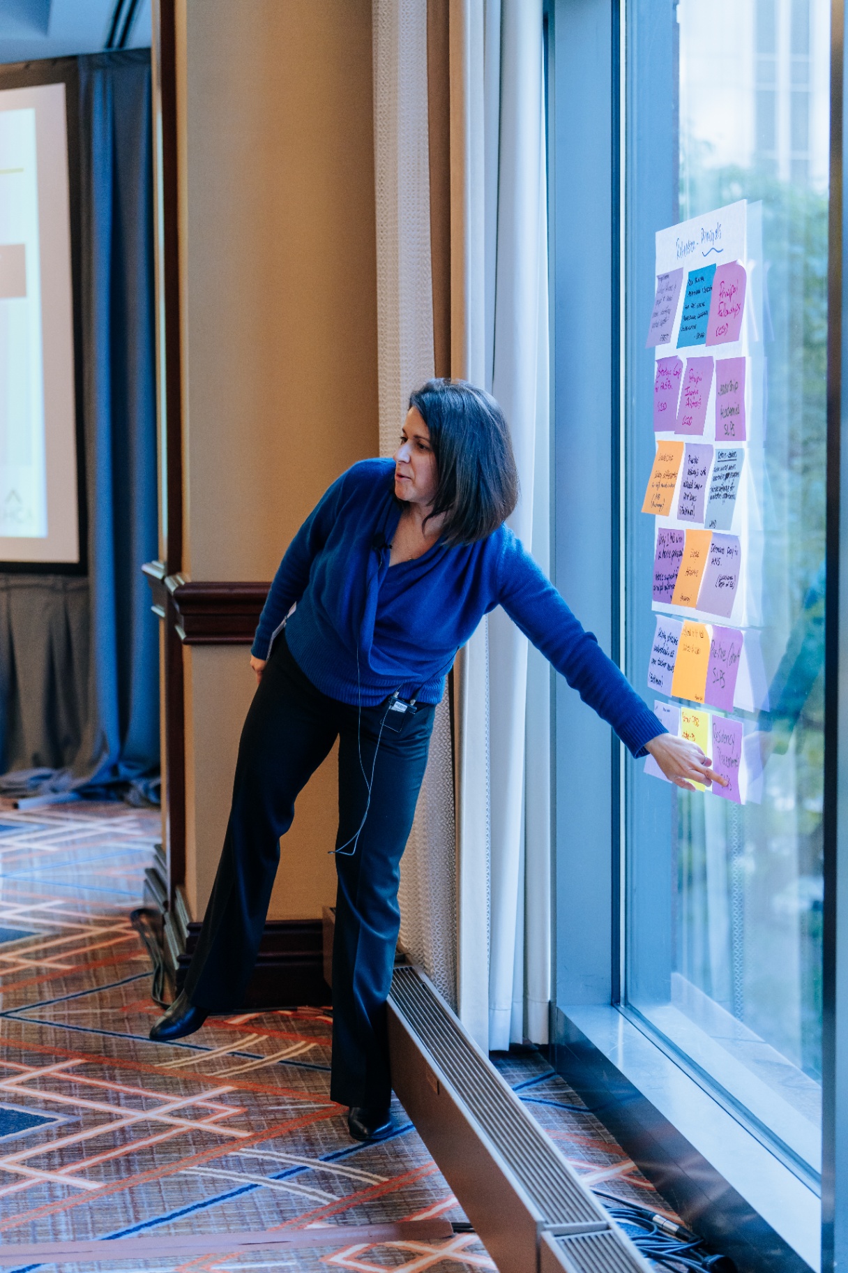 Leader organizing insights on sticky notes